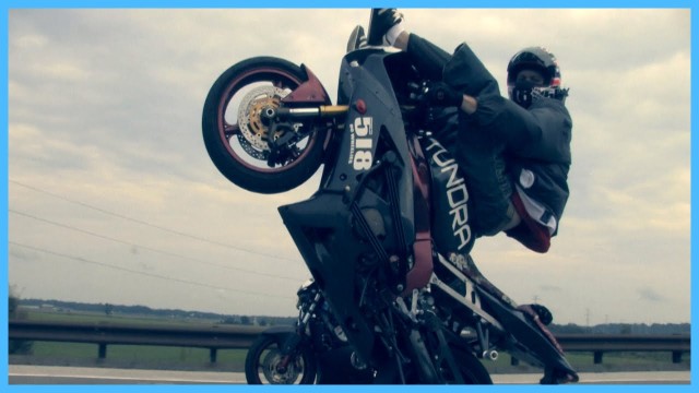 Stunt Rider Wheelies With Feet Over Winshield