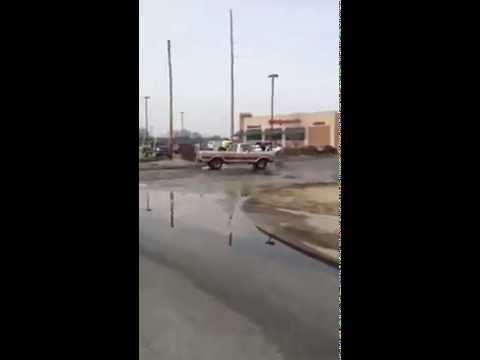 Running truck slips into gear while man is in the store